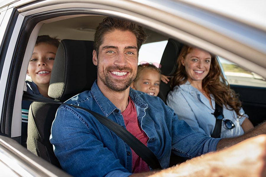 Personal Insurance - Closeup Portrait of a Happy Family Getting Ready for a Road Trip in the Car